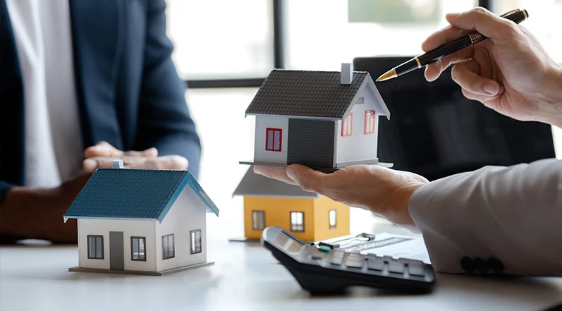 Hand holding a model house