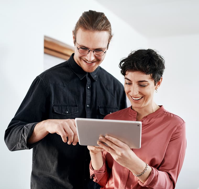 Man and woman reviewing plans on a tablet