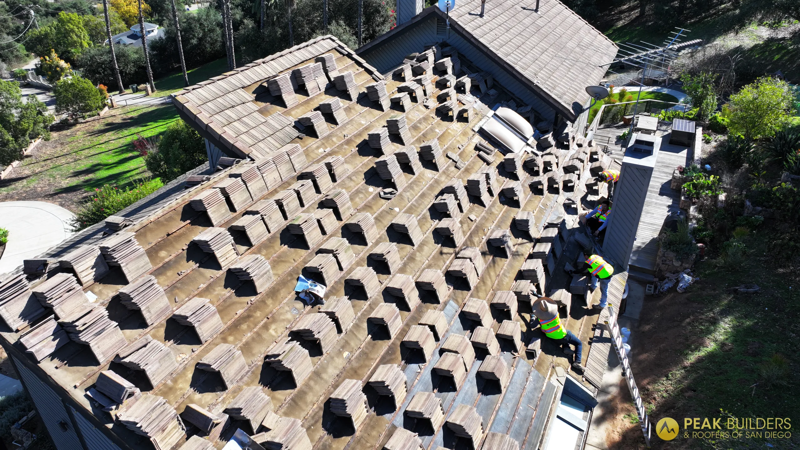 Roofers working on a tile roof